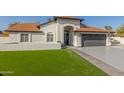 Two-car garage and well-manicured lawn at 3450 N 67Th Dr, Phoenix, AZ 85033