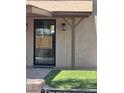 Contemporary front door design with glass panes, neutral stucco, and minimalist porch detail at 36014 N 3Rd St, Phoenix, AZ 85086