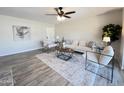 Spacious living room features wood-look floors and plenty of natural light at 3748 W Rovey Ave, Phoenix, AZ 85019