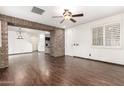 Spacious living room with wood-look tile flooring and stone architectural details at 3883 E Santa Fe Ln, Gilbert, AZ 85297