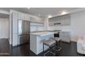 Modern kitchen with stainless steel appliances, a kitchen island and dark wood flooring at 4422 N 75Th St # 3012, Scottsdale, AZ 85251