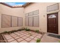 Private courtyard features tiled patio and desert landscaping at 5421 W Brown St, Glendale, AZ 85302