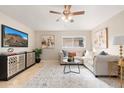 Spacious living room with L-shaped sofa, large TV, and decorative accents at 6201 W Maryland Ave, Glendale, AZ 85301