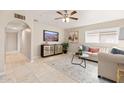 Bright living room features a comfortable sofa and large windows at 6201 W Maryland Ave, Glendale, AZ 85301