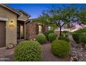 Landscaped front yard with stone accents and lush greenery at 7635 W Rock Springs Dr, Peoria, AZ 85383