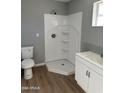 Bathroom with a white shower stall and modern fixtures at 8023 E Irwin Ave, Mesa, AZ 85209