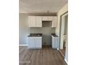 Modern kitchen with white cabinets and granite countertops at 8023 E Irwin Ave, Mesa, AZ 85209