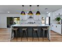Beautiful kitchen with a waterfall island, breakfast bar seating, and modern stainless steel appliances at 8024 E Hubbell St, Scottsdale, AZ 85257