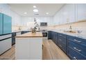 Updated kitchen featuring teal fridge, white and blue cabinets, and a marble center island at 8413 E Sheridan St, Scottsdale, AZ 85257