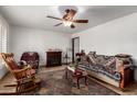 Cozy living room with a ceiling fan, fireplace and comfortable furniture with southwest designs at 9618 W Appaloosa Dr, Sun City, AZ 85373