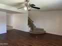 Open-concept living area featuring wood floors and staircase at 1550 N Stapley Dr # 35, Mesa, AZ 85203