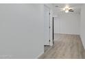 Interior hallway with light gray walls and wood-look flooring at 18202 N Cave Creek Rd # 241, Phoenix, AZ 85032