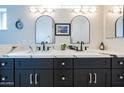 Elegant bathroom with dual vanity, marble countertop, and arched mirrors at 2016 E Pegasus Dr, Tempe, AZ 85283