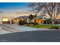 Exterior view of home featuring a three-car garage and spacious driveway at 22477 S 197Th Cir, Queen Creek, AZ 85142