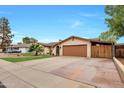 House exterior showcasing a front yard, driveway, and garage at 2323 E Concorda Dr, Tempe, AZ 85282