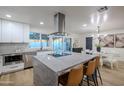 Modern kitchen featuring a large island, stainless steel appliances, and quartz countertops at 2408 W Willow Ave, Phoenix, AZ 85029