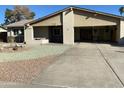 Two-car garage and driveway, rock landscaping in front at 3723 W Helena Dr, Glendale, AZ 85308