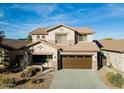 Inviting two-story home with an attached two-car garage and well manicured lawn at 44250 W Vineyard St, Maricopa, AZ 85139