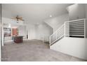 Open living area with modern kitchen, staircase, and tile floors at 6745 N 93Rd Ave # 1138, Glendale, AZ 85305