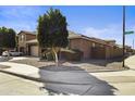 Corner lot featuring a charming single-story home with desert landscaping, a two-car garage at 676 N 156Th Ln, Goodyear, AZ 85338
