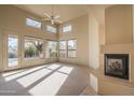 Spacious living room with high ceilings, fireplace, and large windows at 7131 E Canyon Wren Cir, Scottsdale, AZ 85266