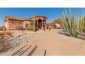 Pathway to home features gravel and desert plants, leading to the entrance at 8540 E Mcdowell Rd # 55, Mesa, AZ 85207