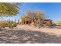 Driveway leads to a beautiful Southwestern style home with mature trees at 8540 E Mcdowell Rd # 55, Mesa, AZ 85207