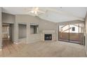 Open living area with high ceilings, fireplace, and kitchen views at 11515 N 91 St # 238, Scottsdale, AZ 85260