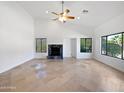 Bright living room featuring a fireplace and tile flooring at 11722 E Starflower Dr, Chandler, AZ 85249