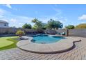 Inviting backyard pool with a spa and artificial turf at 1179 E Coyote Creek Way, San Tan Valley, AZ 85143