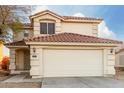 Two-story house with a two-car garage and desert landscaping at 12833 W Laurel Ln, El Mirage, AZ 85335