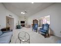 Open floor plan living room and dining room with skylights and ceiling fans at 13861 N 111Th Ave, Sun City, AZ 85351