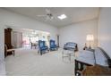 Bright living room with light carpet and a view of the patio dining set at 13861 N 111Th Ave, Sun City, AZ 85351