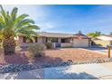 Well-maintained home with desert landscaping, brick accents, and an attached two-car garage at 16302 N 36Th Ave, Phoenix, AZ 85053