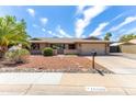 Attractive single-Gathering home with a two-car garage, desert landscaping, and a walkway to the front door at 16302 N 36Th Ave, Phoenix, AZ 85053