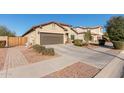 A beautiful single-story home with desert landscaping and an attached two-car garage with a concrete driveway at 17532 W Bajada Rd, Surprise, AZ 85387