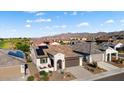 Single-story home with solar panels and mountain views in a residential community at 19063 N 265Th Ave, Buckeye, AZ 85396