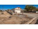 Single-story house with a two-car garage and a side yard at 201 2Nd E Ave, Buckeye, AZ 85326