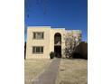 Two-story building exterior with tan stucco and arched entryway at 2108 E Dunbar Dr, Tempe, AZ 85282