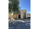 Front view of two-story home with arched entryway and desert landscaping at 2125 E Dunbar Dr, Tempe, AZ 85282