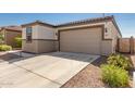 House exterior showcasing a two-car garage and well-manicured landscaping at 2427 W Kowalsky Ln, Phoenix, AZ 85041