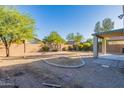 Landscaped backyard with gravel and a grassy area at 2438 W Gambit Trl, Phoenix, AZ 85085