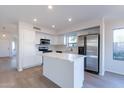 Modern kitchen with white cabinets and a kitchen island at 2438 W Gambit Trl, Phoenix, AZ 85085