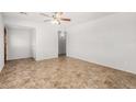 Bright living room featuring a ceiling fan and light-colored paint at 2906 W Alice Ave, Phoenix, AZ 85051