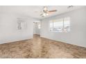 Bright living room featuring a ceiling fan and lots of natural light at 2906 W Alice Ave, Phoenix, AZ 85051