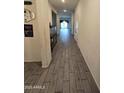 Long hallway with wood-look tile floors and access to other rooms at 3014 N Majestic Ct, Casa Grande, AZ 85122