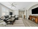 Open living area with dark sofa, wood floors, decorative rug, and natural lighting at 3021 E Agritopia N Loop, Gilbert, AZ 85296