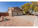 Two-story house with a two-car garage and a side yard at 31292 N Candlewood Dr, San Tan Valley, AZ 85143