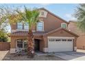 Charming two-story home features a two-car garage, desert landscaping, and a cozy front porch at 3209 W Apollo Rd, Phoenix, AZ 85041