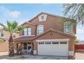 Charming two-story home features a two-car garage, desert landscaping, and a cozy front porch at 3209 W Apollo Rd, Phoenix, AZ 85041